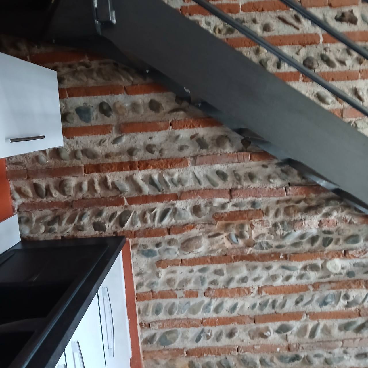Mur de galets traité — surface nettoyée, galets brillants, joints repris