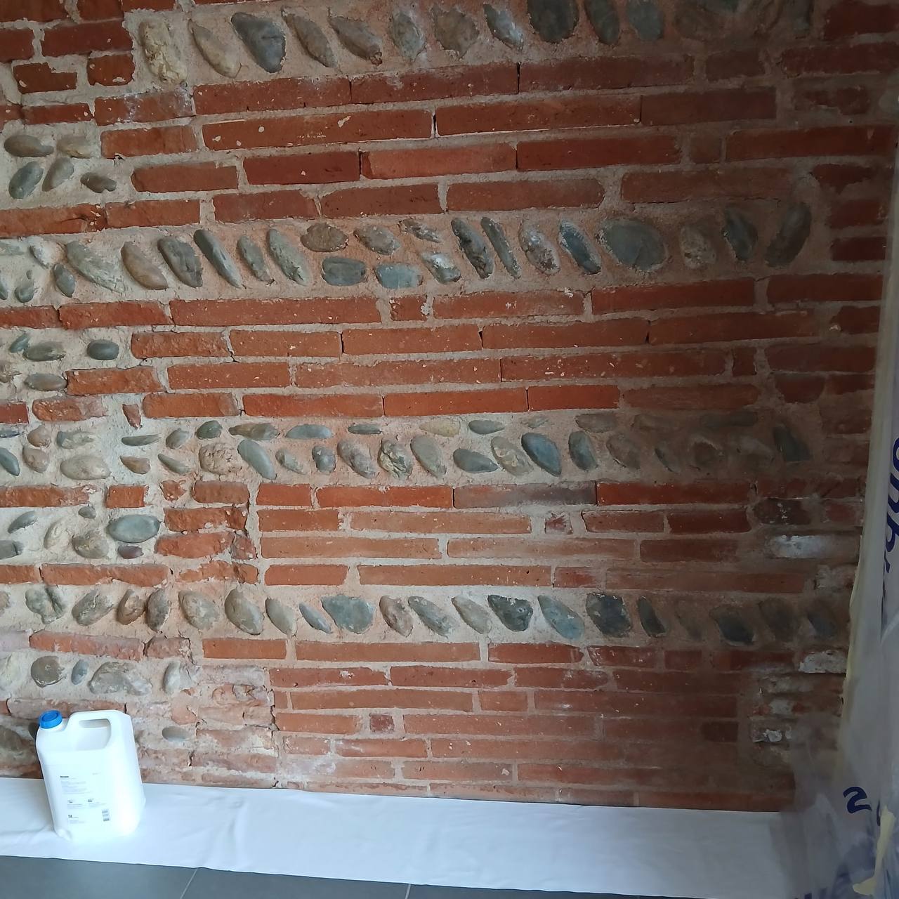 Mur complet avec jerrican de produit de traitement au sol — préparation du chantier
